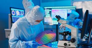 NES-Worker-Inspecting-Wafer-2022.jpeg